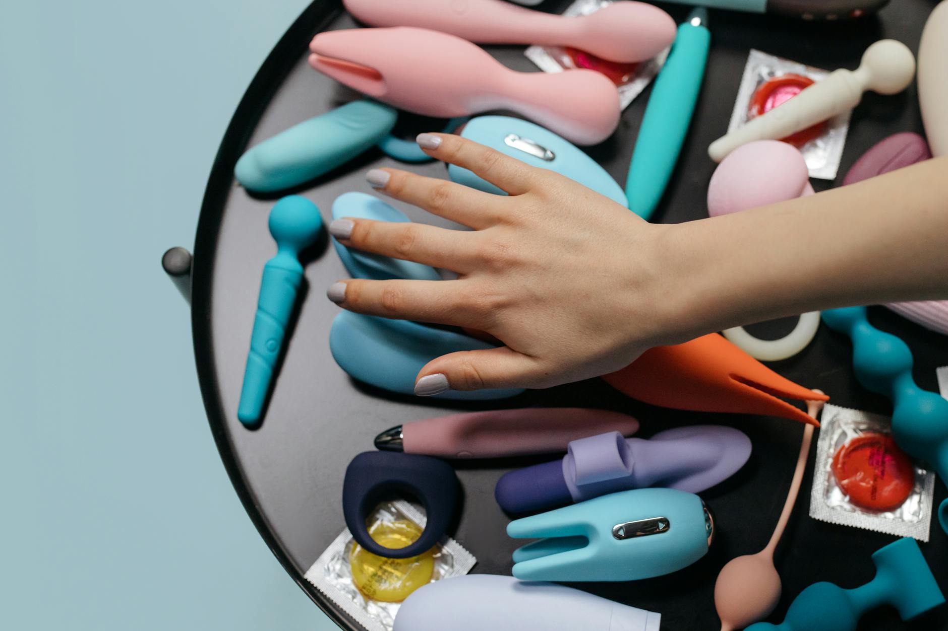 Close-up of hands holding a personal massager, representing safe self-exploration and healing