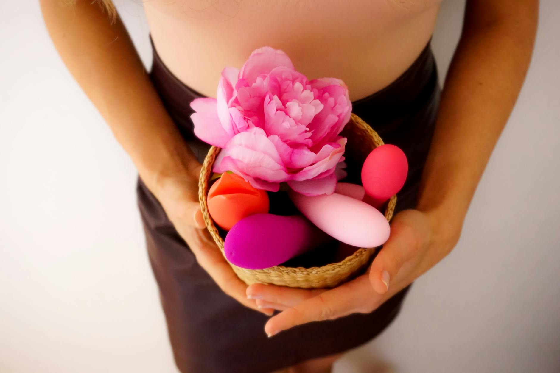 Three colorful vibrators arranged on white fabric, highlighting smooth texture and design