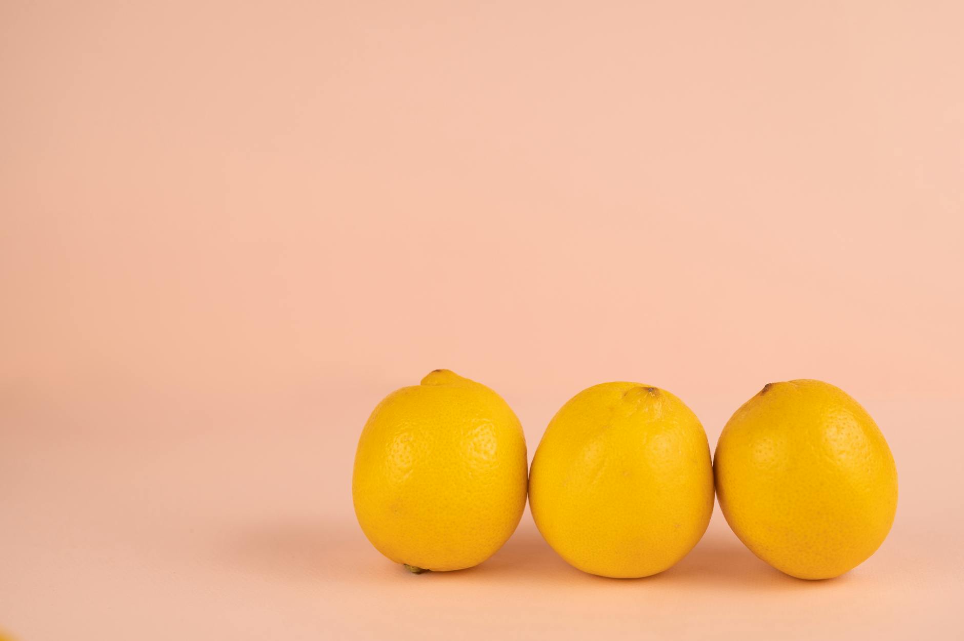 Fresh bright lemons arranged on a pastel background